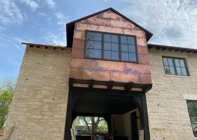 Copper metal panel facade on a stone building for Roof Repair in Doraville