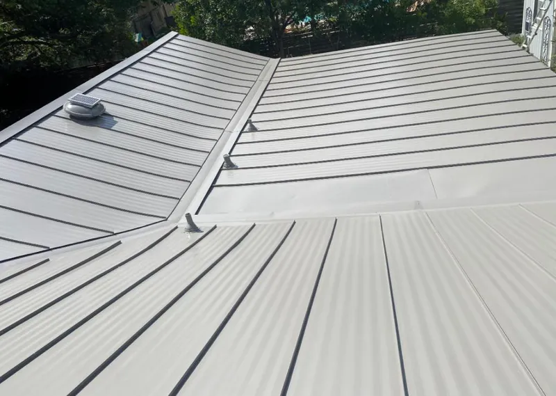 Solar attic fan installed on a metal roof for Roof Ventilation in Doraville